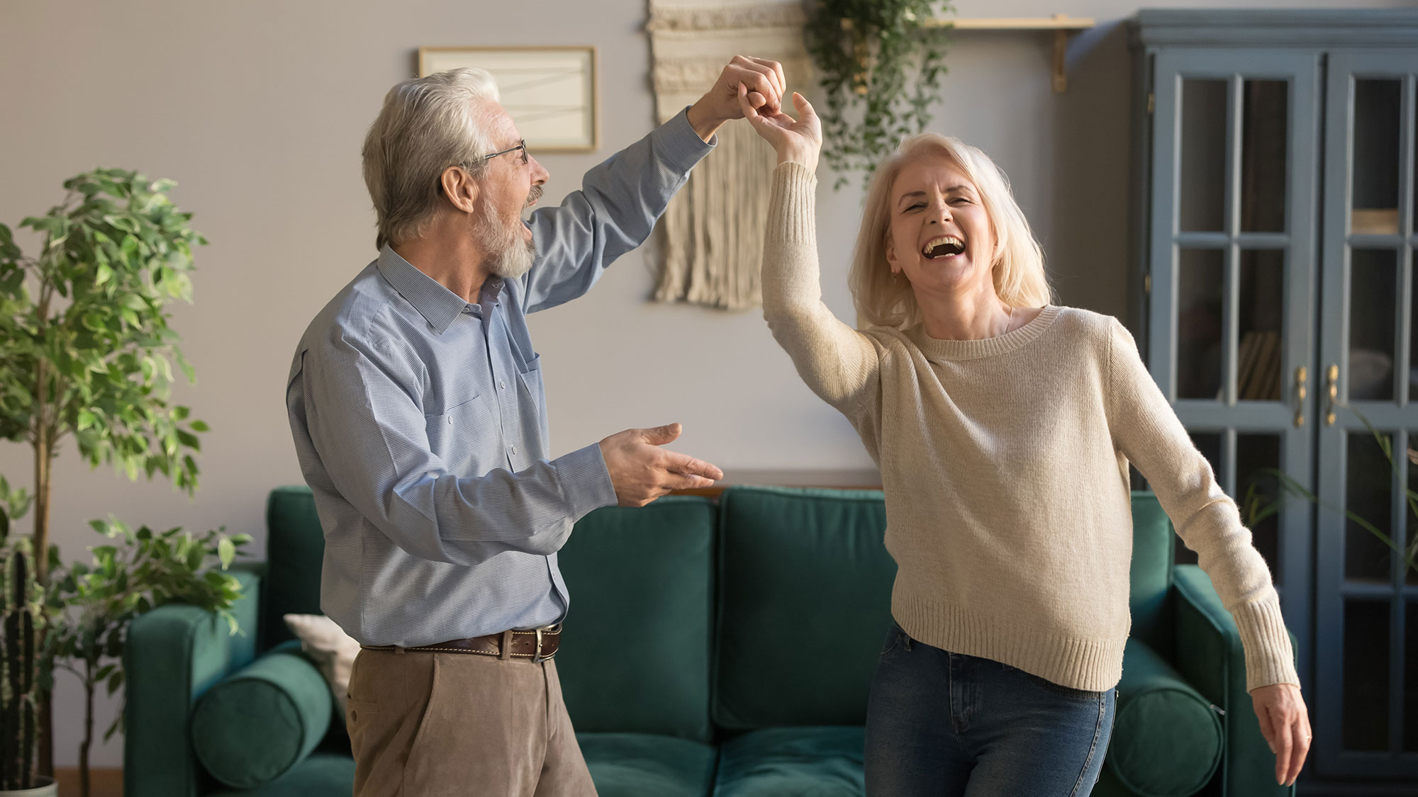 Older couple dancing together and enjoying an active, joyful lifestyle.